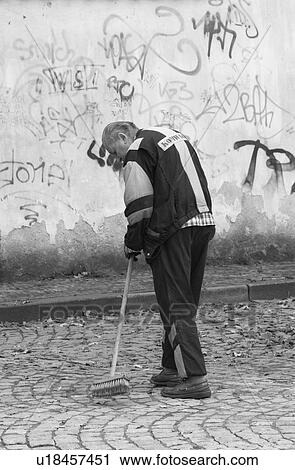 Rear view of man cleaning the streets in Prague View Large Photo Image Stock Image - Rear view of man cleaning the streets in Prague. Fotosearch