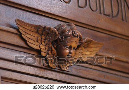 Stone carvings of an angel on a building in Montreal, Canada View Large Photo Image Stock Photograph - Stone carvings of an angel on a building in Montreal, Canada. Fotosearch