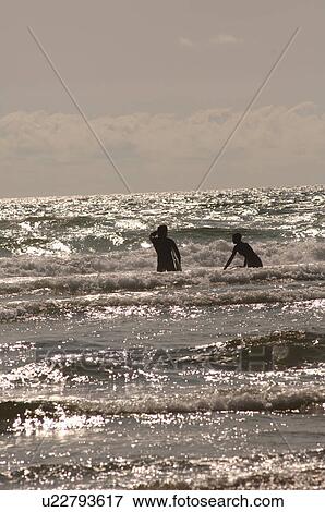 Stock Photo - Surfers in Ocean, Pacific Rim Park, Vancouver Island, Canada. Fotosearch