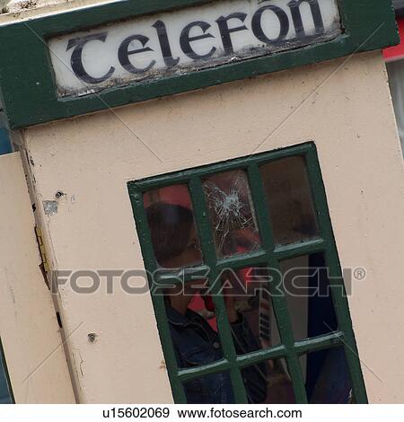 Stock Photo - Woman in phone booth. Fotosearch