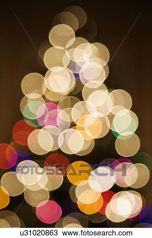 Stock Image - Abstract Christmas tree with blurred multicolored lights. Fotosearch