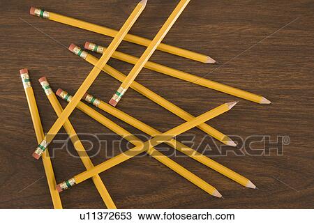 Stock Image - Aerial view of wooden pencils scattered on desktop. Fotosearch