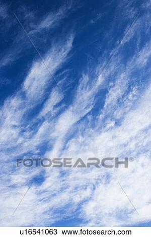 Beautiful blue sky with light wispy clouds View Large Photo Image Stock Image - Beautiful blue sky with light wispy clouds. Fotosearch