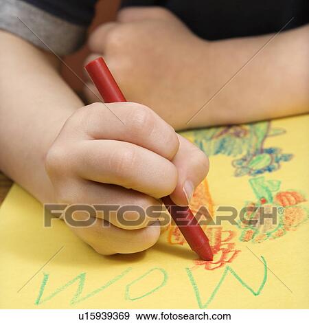 Boy drawing on yellow paper with crayons View Large Photo Image Stock Photo - Boy drawing on yellow paper with crayons. Fotosearch