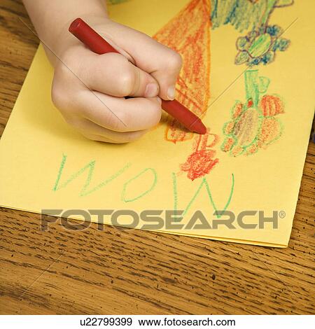 Boy drawing on yellow paper with crayons View Large Photo Image Stock Photo - Boy drawing on yellow paper with crayons. Fotosearch