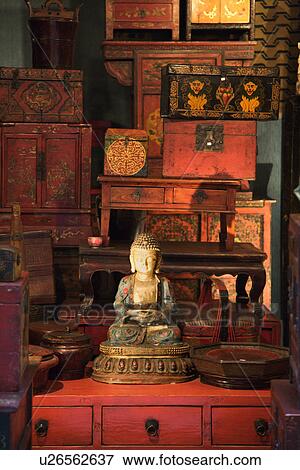 Stock Photo - Buddha statue in antique store. Fotosearch