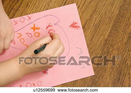 Child hands drawing on paper with crayons View Large Photo Image Stock Photo - Child hands drawing on paper with crayons. Fotosearch