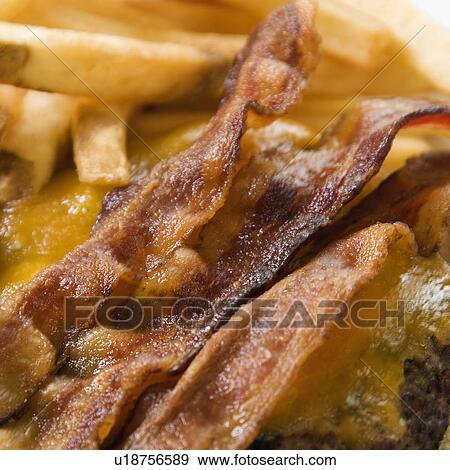 Close up of bacon cheeseburger with french fries View Large Photo Image Stock Photo - Close up of bacon cheeseburger with french fries. Fotosearch