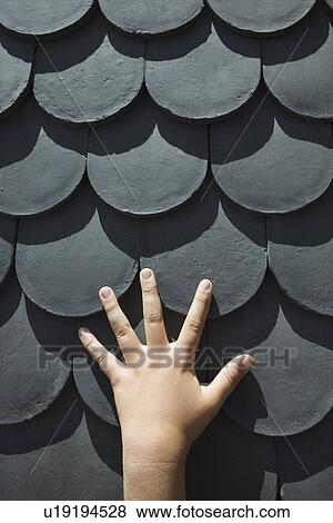 Close-up of boy's hand on rooftop with scale shaped shingles in Lisbon, Portugal. View Large Photo Image Stock Photo - Close-up of boy's hand on rooftop with scale shaped shingles in Lisbon, Portugal.. Fotosearch