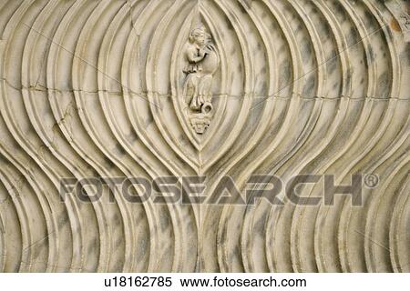 Stock Photography - Close-up of engraved couple surrounded by line pattern in Rome, Italy. Fotosearch