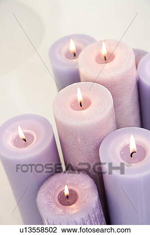 Close up of lit lavender candles View Large Photo Image Stock Image - Close up of lit lavender candles. Fotosearch