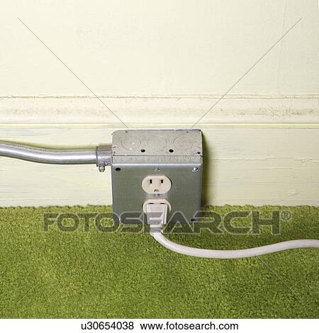 Close-up of silver wall outlet with plug inserted View Large Photo Image Stock Photo - Close-up of silver wall outlet with plug inserted. Fotosearch