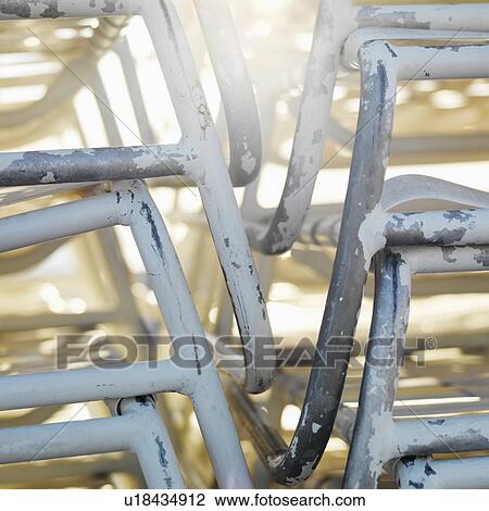 Stock Image - Close-up of stacked worn beach chairs in Miami, Florida, USA. Fotosearch
