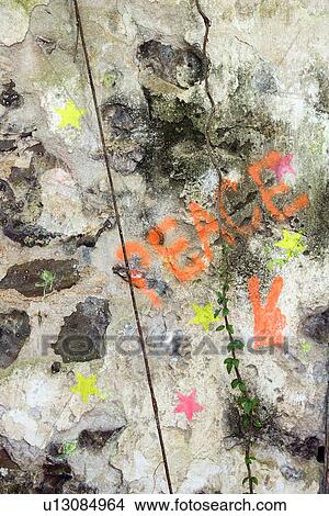 Close-up of the word peace and stars spray painted on concrete View Large Photo Image Picture - Close-up of the word peace and stars spray painted on concrete. Fotosearch