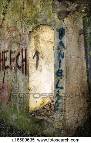 Stock Photography - Doorway of abandoned building with spray painted graffiti. Fotosearch
