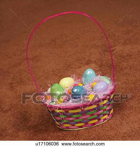 Easter basket filled with eggs and candy View Large Photo Image Stock Photograph - Easter basket filled with eggs and candy. Fotosearch