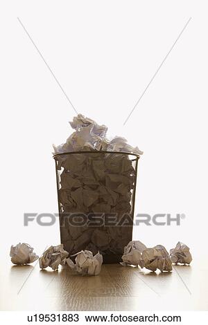 Full wire mesh trash can with crumpled paper scattered around View Large Photo Image Stock Image - Full wire mesh trash can with crumpled paper scattered around. Fotosearch