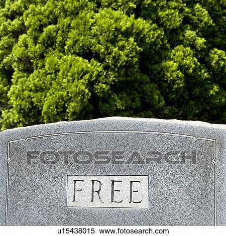 Stock Photography - Gravestone against trees with word 'Free' on it. Fotosearch