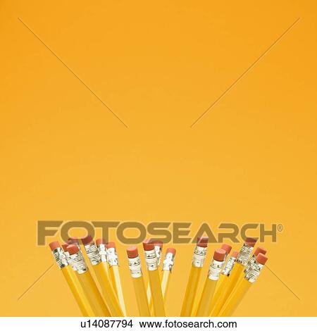 Picture - Group of eraser ends of pencils on orange background. Fotosearch