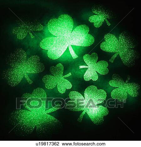 Group of green shamrocks reflecting light on black background View Large Photo Image Stock Image - Group of green shamrocks reflecting light on black background. Fotosearch