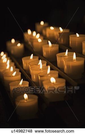 Stock Photo - Group of lit candles in Rome, Italy. Fotosearch