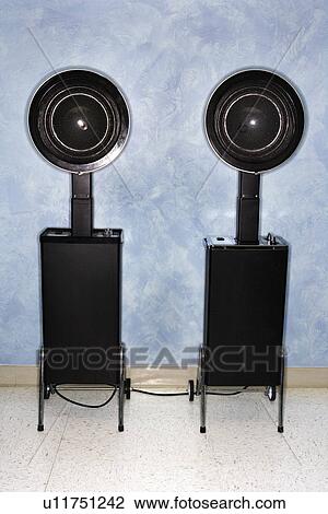 Stock Image - Hair styling and drying chairs at women's salon.. Fotosearch