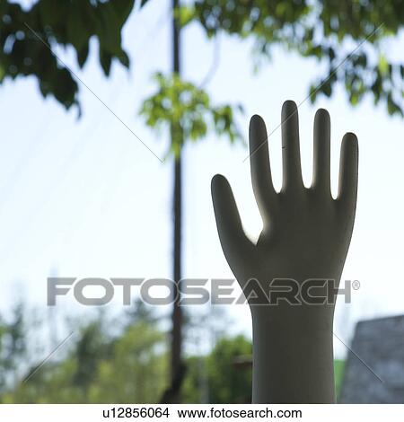 Picture - Hand statue silhouetted against sky. Fotosearch
