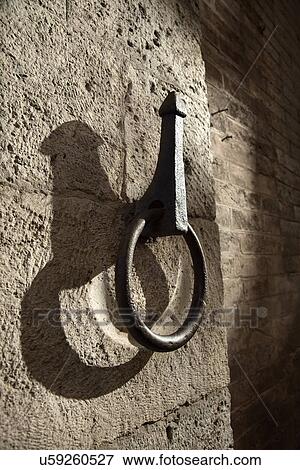 Stock Photo - Metal hitching post on stone wall. Fotosearch