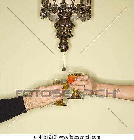 Mid-adult couples hands toasting glasses View Large Photo Image Stock Photo - Mid-adult couples hands toasting glasses. Fotosearch