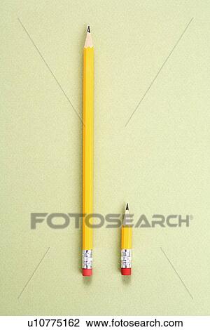 Stock Image - One long pencil and one short pencil placed side by side in comparison. Fotosearch