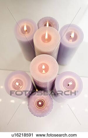 Overview of purple burning candles in front of mirror View Large Photo Image Stock Image - Overview of purple burning candles in front of mirror. Fotosearch
