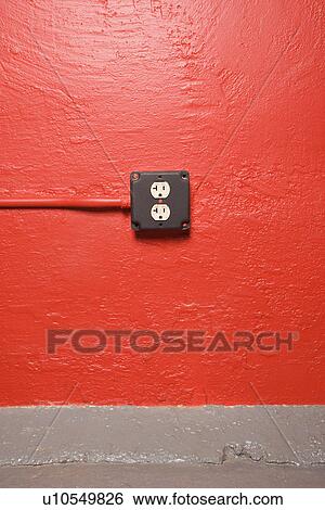 Stock Photograph - Red wall with electrical outlet. Fotosearch