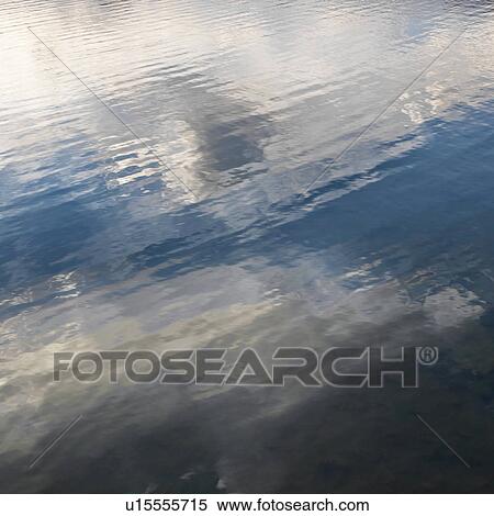 Reflections of cloud formations on rippling water View Large Photo Image Stock Photography - Reflections of cloud formations on rippling water. Fotosearch