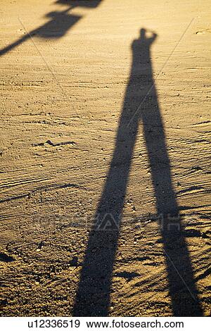 Shadow of man on dirt at sundown View Large Photo Image Stock Photo - Shadow of man on dirt at sundown. Fotosearch