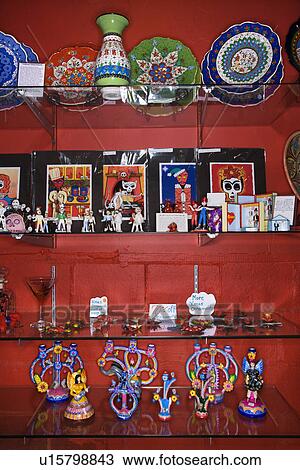 Stock Image - Shelves of unique folk art in retail store. Fotosearch