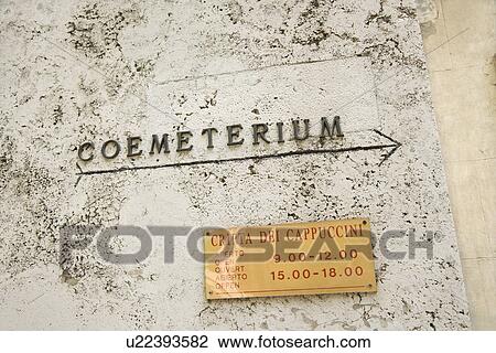 Stock Image - Sign with arrow directing towards coemeterium in Rome, Italy. Fotosearch