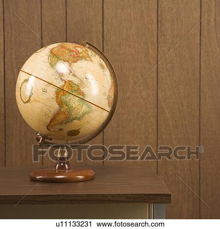 Sill life shot of a vintage world globe sitting on a desk View Large Photo Image Stock Image - Sill life shot of a vintage world globe sitting on a desk. Fotosearch