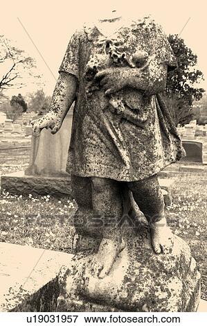Statue in graveyard of headless cherub View Large Photo Image Stock Photo - Statue in graveyard of headless cherub. Fotosearch