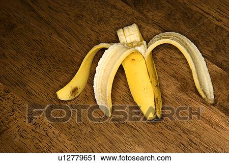 Still life of half eaten banana on wooden table View Large Photo Image Stock Image - Still life of half eaten banana on wooden table. Fotosearch