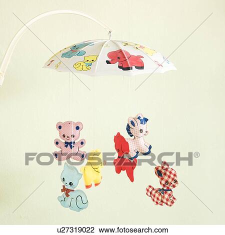 Stock Image - Still life of vintage baby mobile with colorful moving animals. Fotosearch