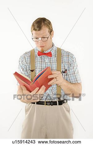 Young man dressed like nerd reading book View Large Photo Image Stock Image - Young man dressed like nerd reading book. Fotosearch