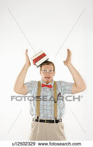 Young man dressed like nerd with books sliding off head View Large Photo Image Stock Photo - Young man dressed like nerd with books sliding off head. Fotosearch