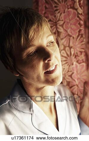 Picture - Close-up of a mature woman looking away. Fotosearch