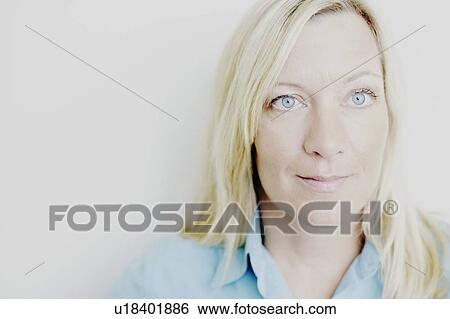 Close-up of a mature woman smirking View Large Photo Image Stock Photograph - Close-up of a mature woman smirking. Fotosearch