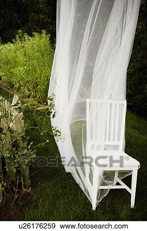 High angle view of a chair and a curtain in a garden View Large Photo Image Stock Photo - High angle view of a chair and a curtain in a garden. Fotosearch