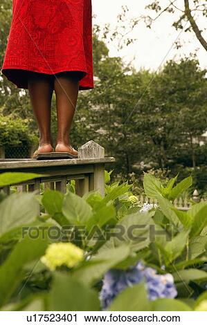 Low section view of a mid adult woman standing on a railing in a park View Large Photo Image Stock Image - Low section view of a mid adult woman standing on a railing in a park. Fotosearch