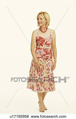 Stock Photo - Mature woman smiling and looking away. Fotosearch