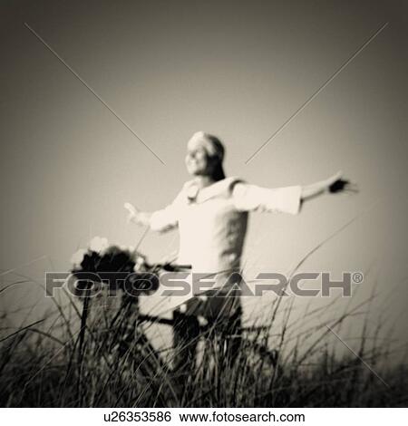Mature woman standing with her arms outstretched View Large Photo Image Stock Photograph - Mature woman standing with her arms outstretched. Fotosearch