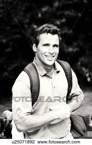 Stock Image - Portrait a mature man carrying a golf bag. Fotosearch