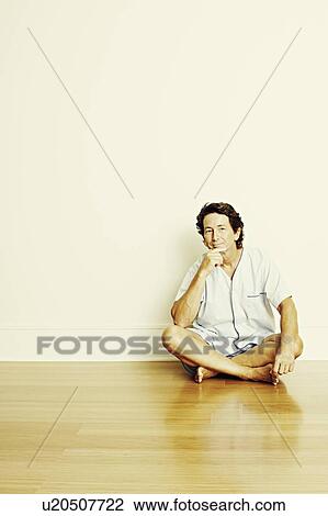 Portrait of a mature man sitting cross-legged on the floor and thinking View Large Photo Image Stock Image - Portrait of a mature man sitting cross-legged on the floor and thinking. Fotosearch